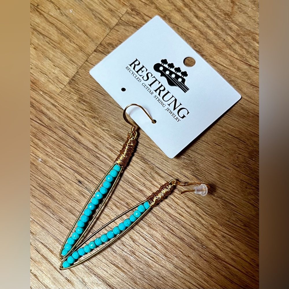 Handmade, restrung earrings made from recycled guitar strings. New in box.